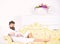 Luxury life concept. Man sleepy in bathrobe drinks coffee in luxury hotel in morning, white background. Man with beard