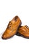 Luxury Male Footwear. Partial Closeup of A Pair of Full Broggued Tan Leather Oxfords Shoes.
