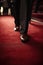 A luxury man feet is walking on Red Carpet in a luxury event for confidence businessman concept.