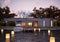 Luxury modern house on water at sunset.