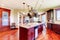 Luxury modern kitchen room with mahogany storage combination .