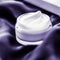 Luxury moisturizing face cream with lavender scent on violet silk, skincare beauty