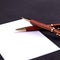Luxury pen and mechanical pencil in wood and gold with a white sheet of paper