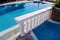 Luxury pool with white balusters. Pool with classic balustrade.