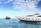 Luxury private motor yachts in tropical sea surface with blue sky clouds sunshine, empty background copy space