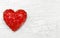 Luxury red heart on white wooden background. Happy Valentines day. Glitter love confetti.