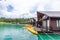 Luxury Resort with Floating Raft Houses on Green Lake with Tropical Trees