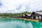 Luxury Resort with Floating Raft Houses on Green Lake with Tropical Trees