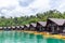 Luxury Resort with Floating Raft Houses on Green Lake with Tropical Trees