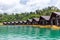 Luxury Resort with Floating Raft Houses on Green Lake with Tropical Trees