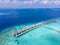 Luxury resort with overwater villas on tropical atoll island for beach holidays vacation travel and honeymoon. Luxurious hotel in