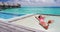 Luxury resort vacation tourist woman relaxing on overwater catamaran net bed