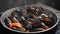 Luxury restaurant. Cooking delicious mussels with hot steam. Slow motion. Pouring dish with white dry wine. Traditional