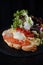 Luxury restaurant croissant stuffed with salad, vegetables, cheese, meat and egg