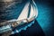 luxury sailing yacht sails on blue ocean water in summer sailing. Top view. Generative AI