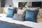 Luxury set of blue and gray pillows on bed
