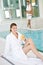 Luxury spa - young woman in bathrobe relax at pool