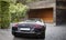 Luxury sports car in front of a garage