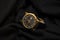 Luxury style golden hand watch on black cloth with business times concept