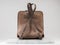 Luxury suet backbag. Luxury brown leather and suet backpack on white background, on marble floor.