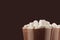 Luxury sweet chocolate dessert in irish coffee glass with  marshmallows closeup, details, top section on dark brown background.