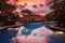 Luxury swiming pool in a tropical resort at sunset