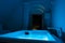 Luxury travel Santorini vacation hotel jacuzzi in colored lights with night view of the city.