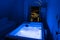 Luxury travel Santorini vacation hotel jacuzzi in colored lights with night view of the city.
