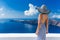 Luxury travel vacation woman looking at Santorini