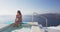 Luxury Travel Woman In Bikini Enjoying Sunset Sea On Santorini, Greece
