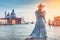 Luxury travel woman looking panorama. Sun hat maxi dress woman relaxing sea view in Venice, Italy. Destination Europe. Concept web