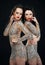 Luxury. Two Glamorous Women in Shiny Dresses
