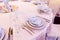 Luxury wedding arrangement of stylish glasses plates on napkins