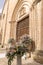 Luxury wedding floral decorations at the entrance of Ostuni church.