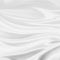 Luxury white background illustration with wavy draped folds of cloth, smooth silk texture with wrinkles and creases in flowing fab