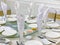 Luxury white banquet table setup with ceramic tableware and glasses