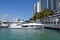 Luxury white motor yacht moored at a condo/marina complex in southeast Florida