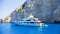 Luxury white yacht navigates into beautiful blue water near Zakynthos Island, Greece.
