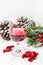 Luxury wine and chocolates with pinecones on a white background.