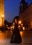 Luxury woman in evening dress at night city going to prom party girl in elegant dress. Fashion and beauty of