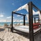 Luxury wooden lounge beds on caribbean beach