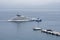 Luxury yacht escorted by a police boat on the Mediterranean Sea