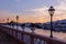 Luxury yacht, footpath, fence and gradient sky at sunset