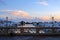 Luxury yacht, pier; building, cloudscape,, gradient sky at sunset