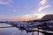 Luxury yacht, pier; building, cloudscape,, gradient sky at sunset