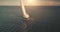 Luxury yacht race in open sea with sun reflections. Serene seascape sailboat. Yachting at ocean bay