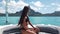 Luxury yacht travel woman enjoying ride on on high end speed boat summer vacation. Elegant black bikini, long hair and