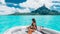 Luxury yacht travel woman enjoying ride on high end speed boat on summer vacation. Elegant black bikini, long hair and