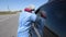 Lviv, Ukraine - April 10, 2020: A medical worker checks temperature of  a driver on a checkpoint on the entrance to Lviv region,