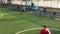 LVIV, UKRAINE - APRIL 14, 2019: Guys in the evening on a sunny day playing football on a mini artificial grass field